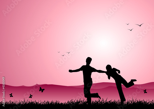 Happy boy and girl running at sunset