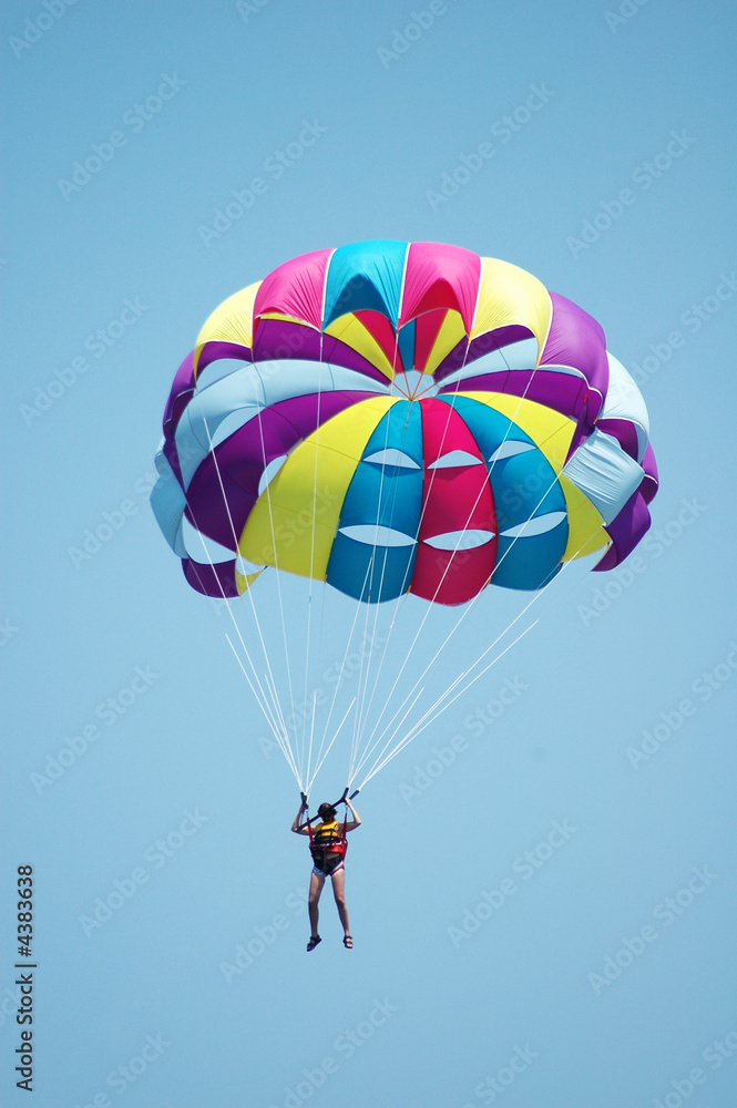 Fototapeta premium Multi coloured parachute over the blue sky