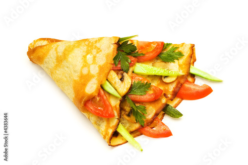 Pancake with cucumbers and tomatoes isolated on white