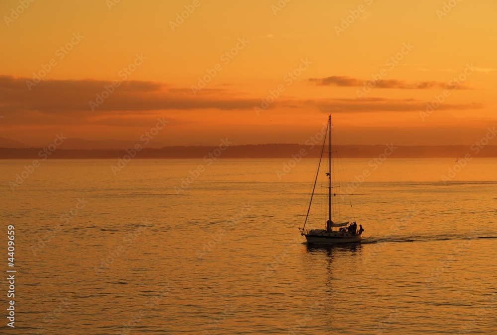 Lone boat sailing in the sunset