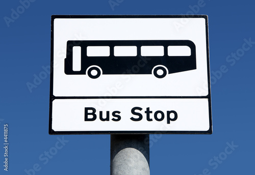 British bus stop sign and a blue sky. photo