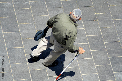 old man with walking stick wearing jewish kippa
