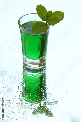 Peppermint liqueur with mint branch on the mirror
