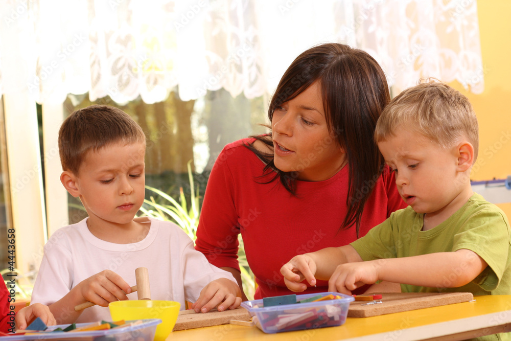 Fototapeta premium preschoolers with wooden blocks