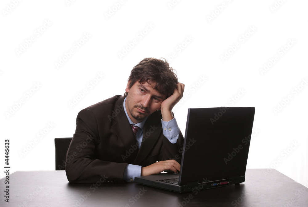 young bored business man working with is laptop young bored business man working with is laptop