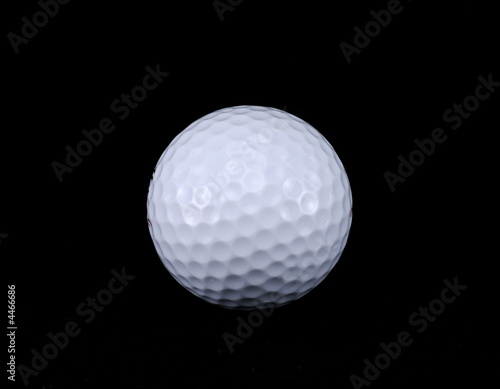 Golf ball isolated on black