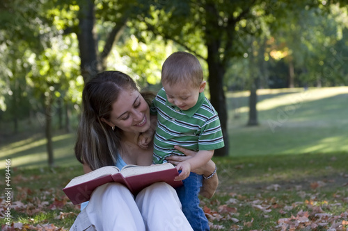 Mother reading a book to her son