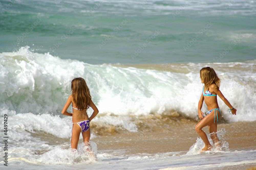 Young girls playing with waves