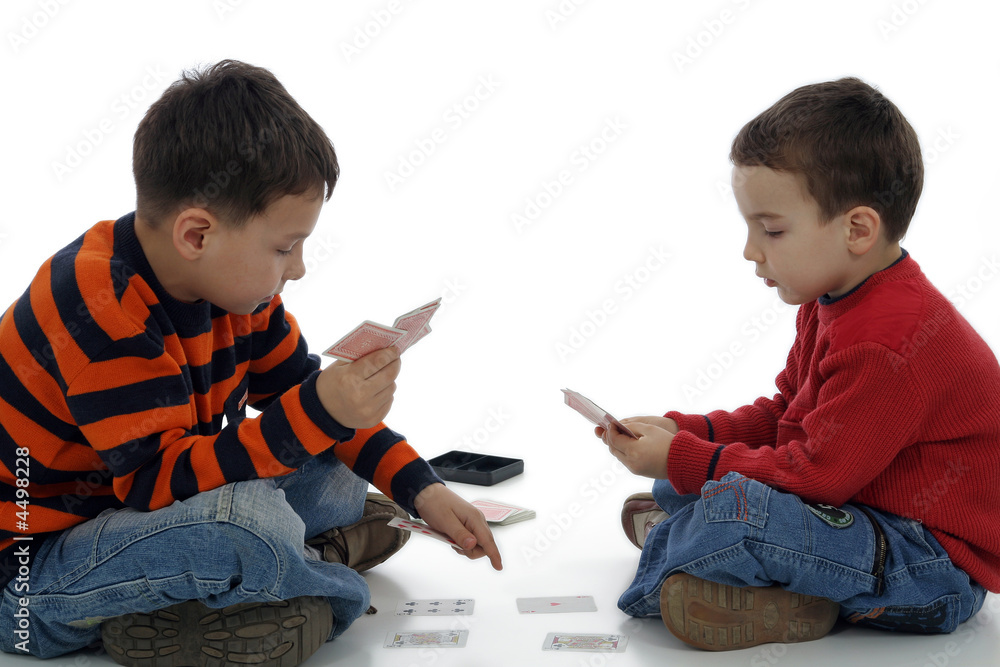 Two little boys playing cards Two little boys playing cards