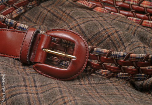 Leather belt over a wool textile fabric