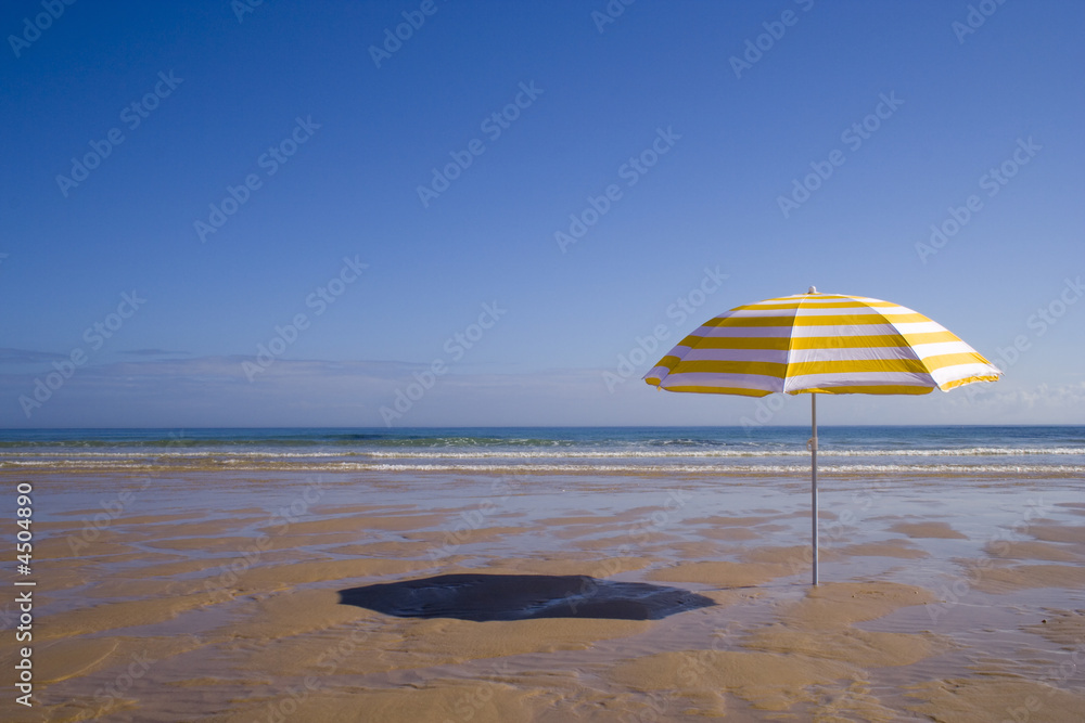 yellow umbrella at the beach