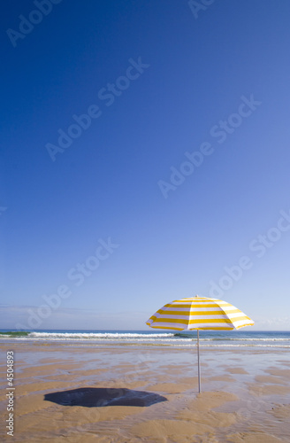 yellow umbrella at the beach