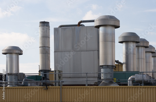 Factory roof with heating and ventilation chimneys