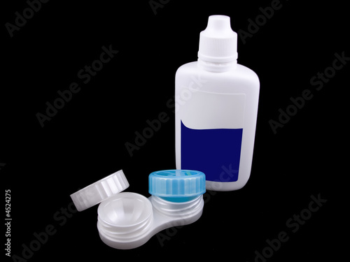 Contact lenses case and liquid. Isolated on black.