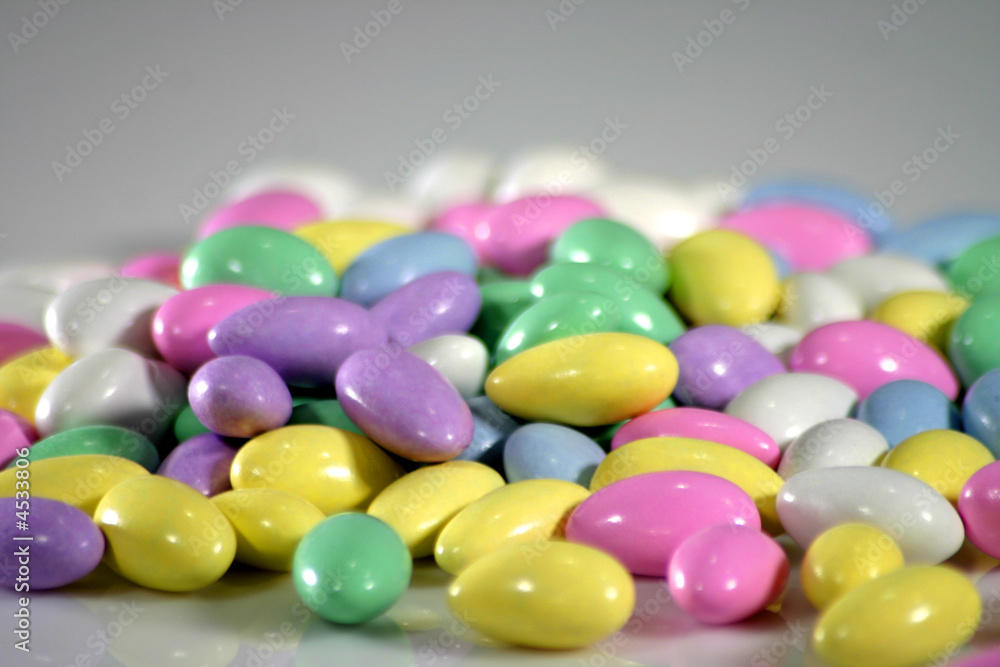 large pile of pastel colored candy almonds with room for text large pile of pastel colored candy almonds with room for text
