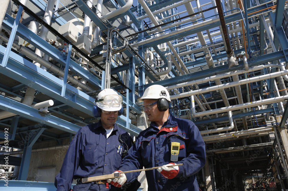 two engineers inside oil refinery two engineers inside oil refinery