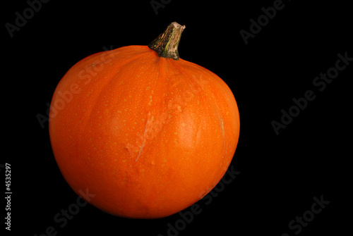Orange pumpkin isolated on black background