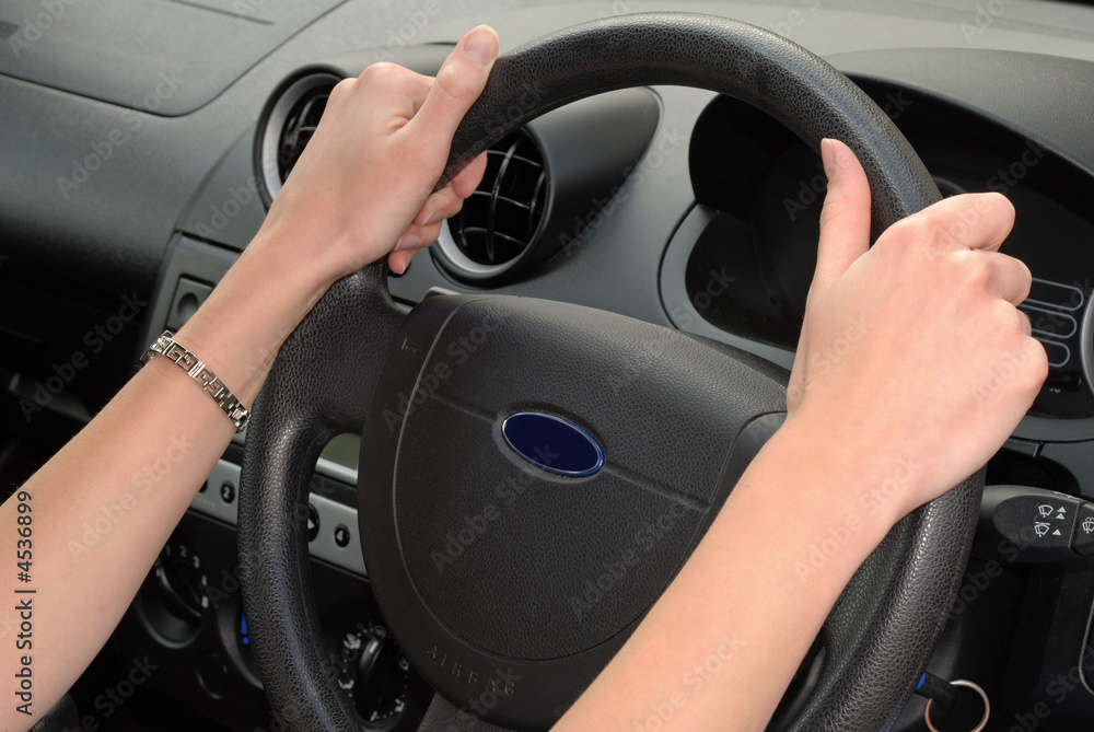 Woman showing correct hand position on steering wheel Stock Photo