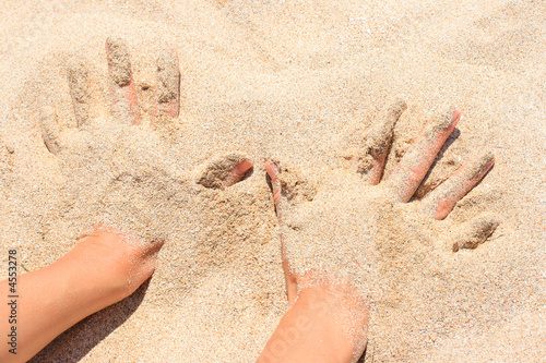 Billede på lærred Hands buried in sand