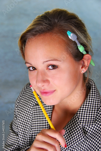 Pretty girl with pencil and toothbrush