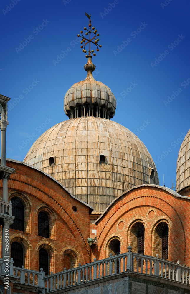 Detail of St. Mark's Basilica against a clear blue sky, in Venic