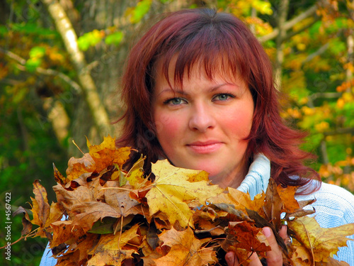 woman with autumn leaves