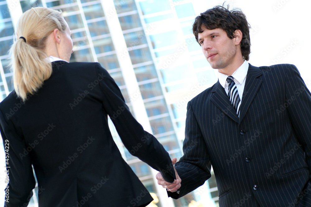 Businesswoman and man shaking hands Businesswoman and man shaking hands