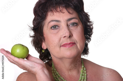 woman holding green apple