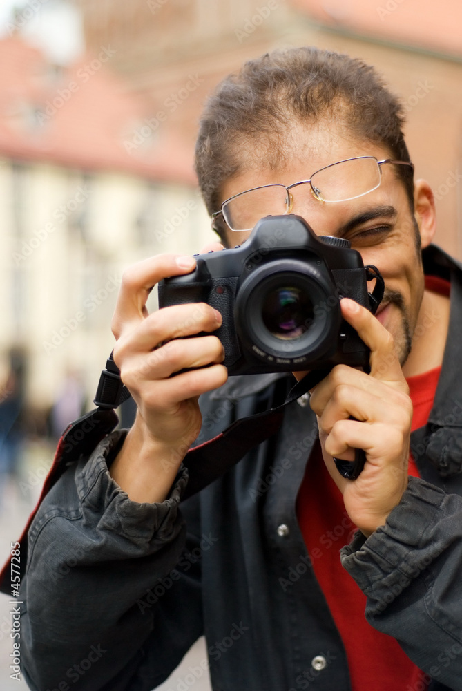 Handsome guy with a digital camera Handsome guy with a digital camera