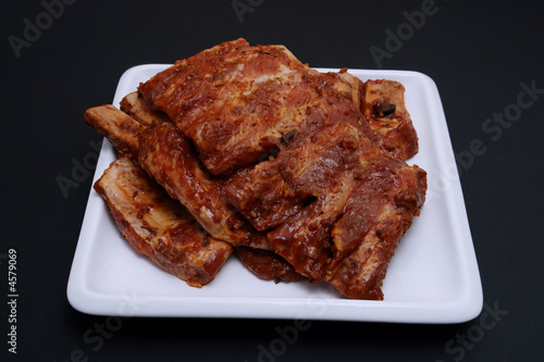 american style spare ribs on square white platter