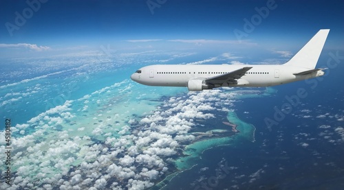 Airliner over exotic island