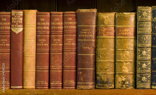 Lots of old books on a bookshelf in library.