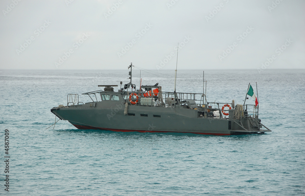 Military patrol boat anchored near the coast Military patrol boat anchored near the coast