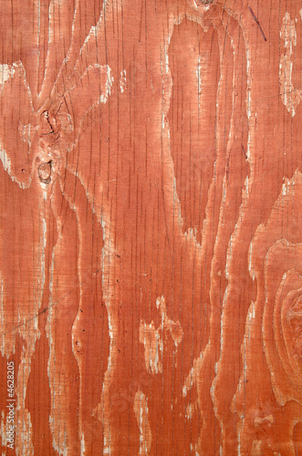 Orange stained wood fence close up background.