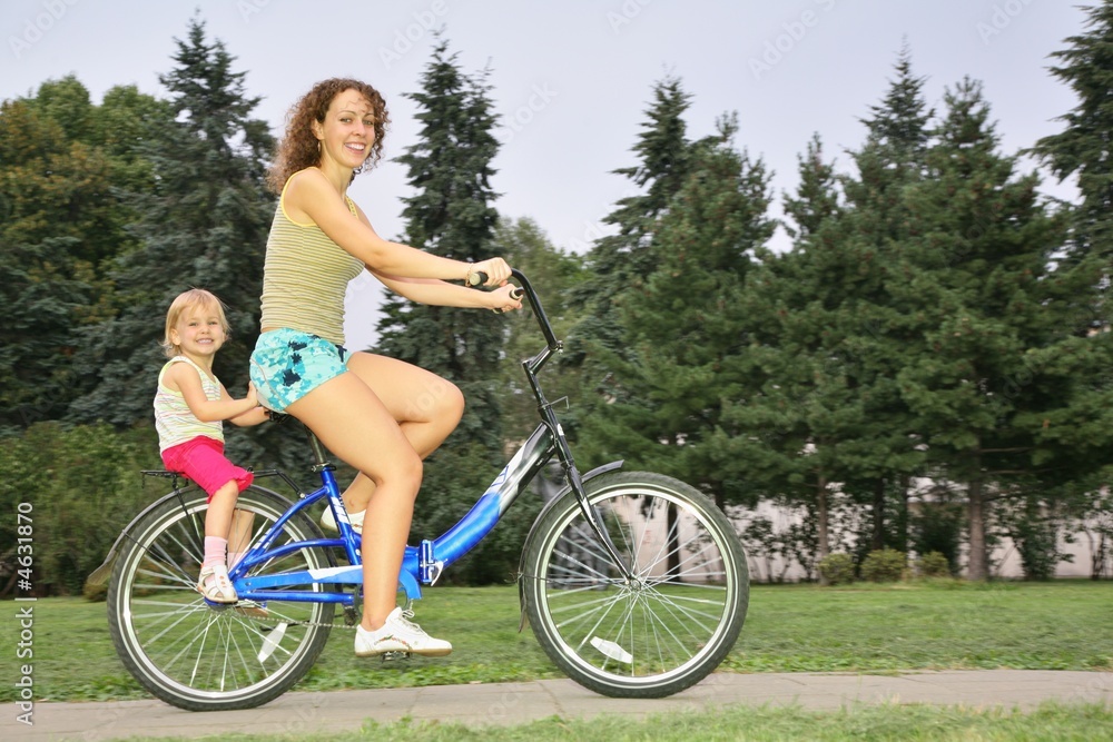 happy mom and daughter on bicycle happy mom and daughter on bicycle
