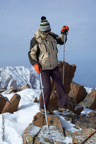 Yong woman travels in winter mountain