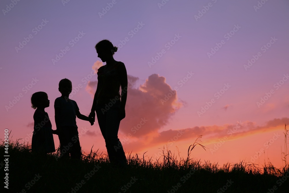 mother and children on sunset