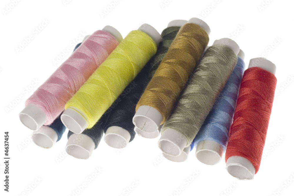 Rows of colorful sewing threads isolated on white background Rows of colorful sewing threads isolated on white background