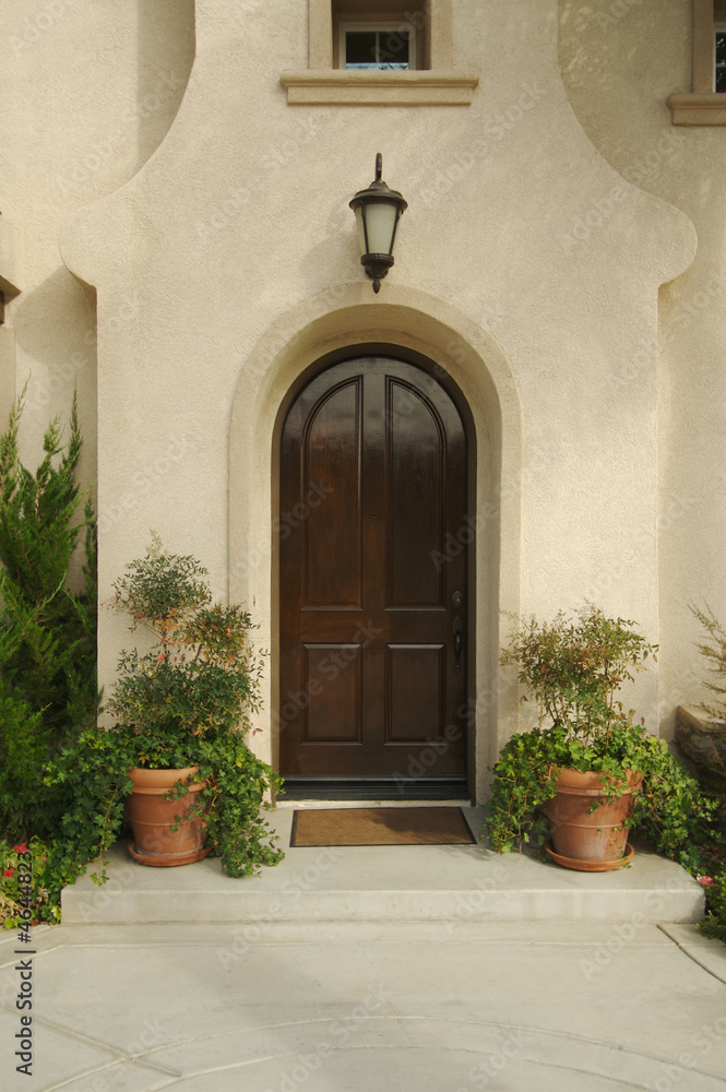 A newly constructed, modern american home doorway and patio.