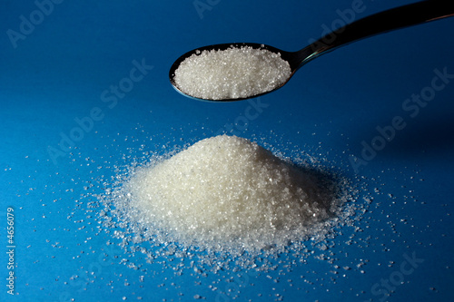 Heap of sugar and a spoon