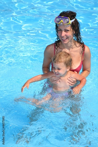 mother with daughter in pool