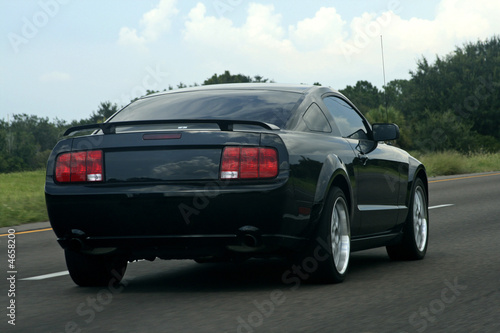black american muscle car on the road