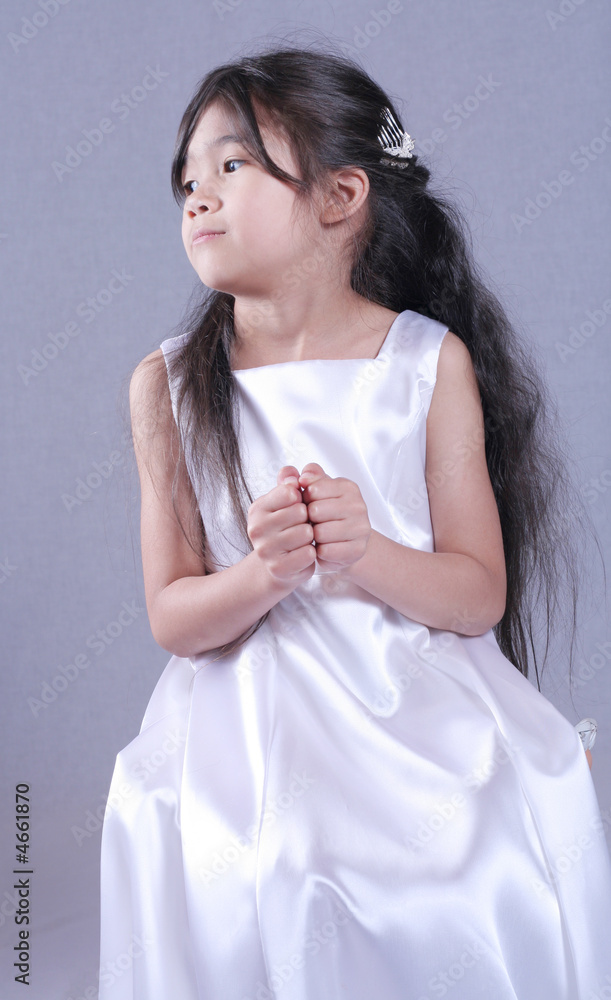 Six years old girl in satin gown playfully posing Six years old girl in satin gown playfully posing