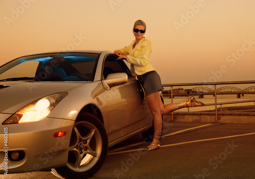 Sexy girl near the modern sport car