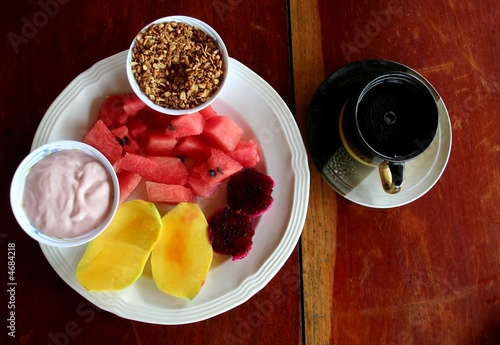 Tropical breakfast with fruit, coffee and cream