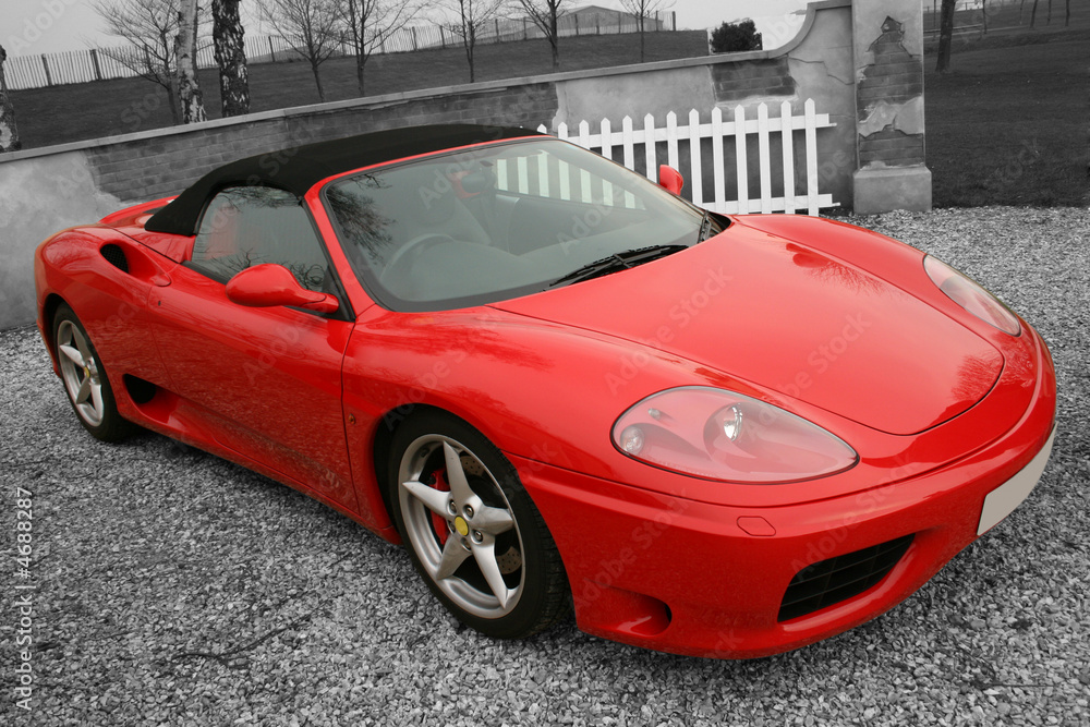 Bright red convertible sports car on a black and white backgroun