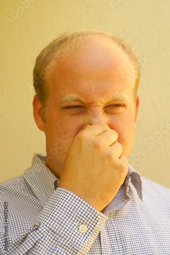 Bed smell (man closing his nostrils) photo