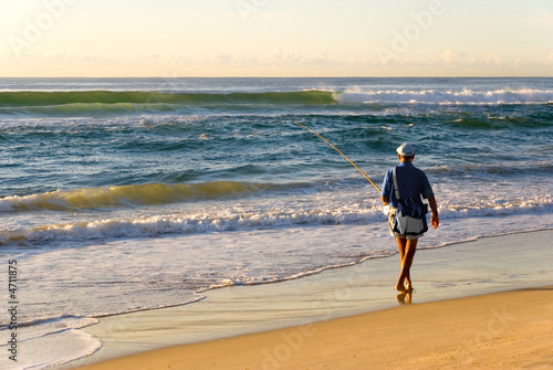 Beach Fisherman by Ocean as Sun rises