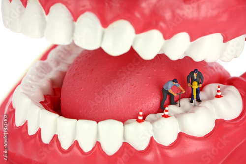 Miniature workers drilling teeth