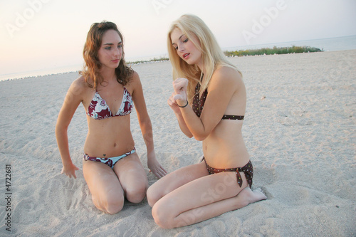 Teen Girls in Bikinis Chat on Beach
